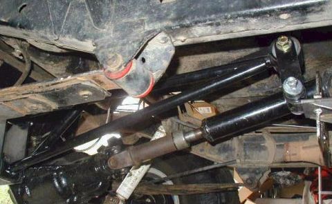 1974 Ford Bronco - Close-up of the undercarriage shows suspension components and a drive shaft.