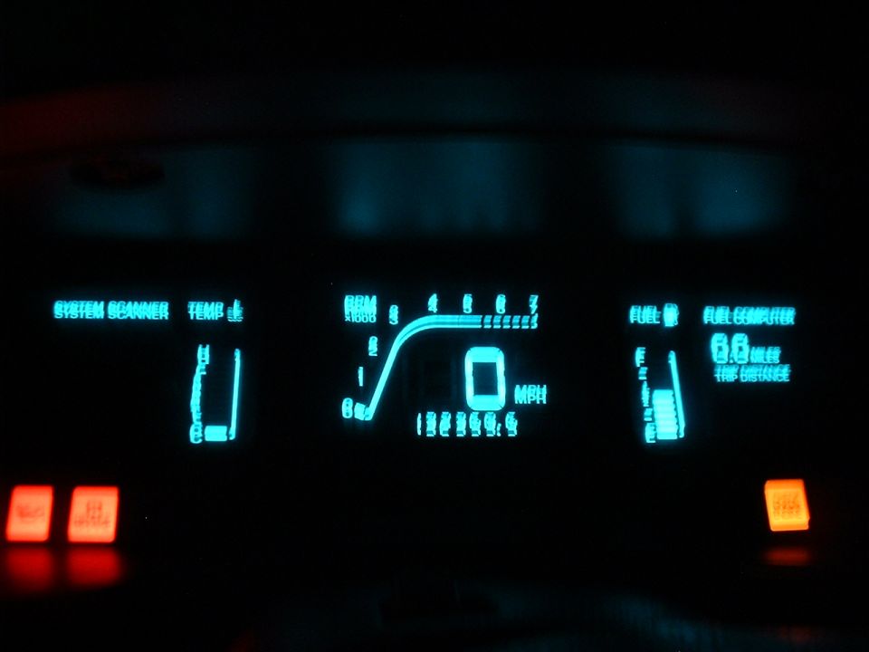Glowing teal digital dash with tachometer, MPH and 132360 odometer reading