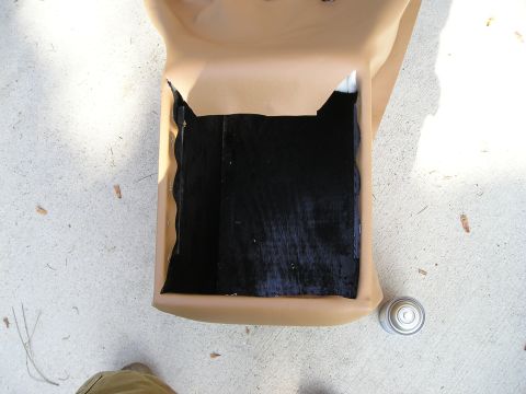 1996 Ford Bronco - A tan-colored vehicle interior part, possibly a center console, is shown outdoors on a concrete surface.