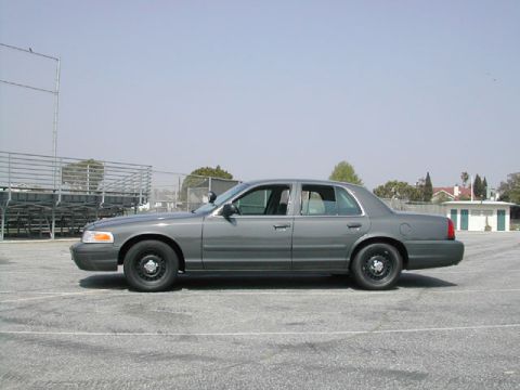 2000 Ford Crown Victoria - Side profile of a gray Ford Crown Victoria, likely a police interceptor model.
