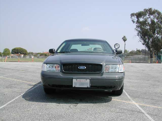 Dark gray 2000 Ford Crown Victoria, front view, parked in a lot