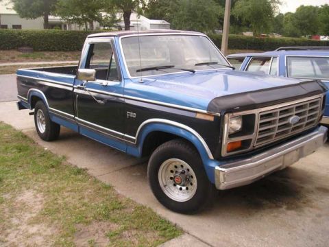 1984 Ford F-150 - This 1984 Ford F-150 pickup truck features a distinctive two-tone blue and black paint scheme.