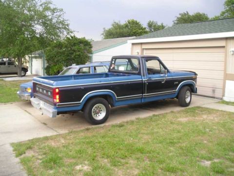 1984 Ford F-150 - This two-tone Ford pickup truck is parked in a residential driveway.