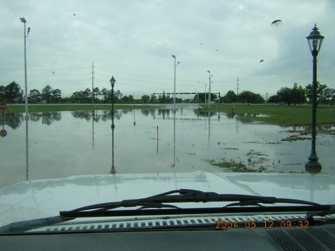 1984 Chevrolet Blazer - View from inside a vehicle looking out at a flooded street with multiple streetlights and trees.