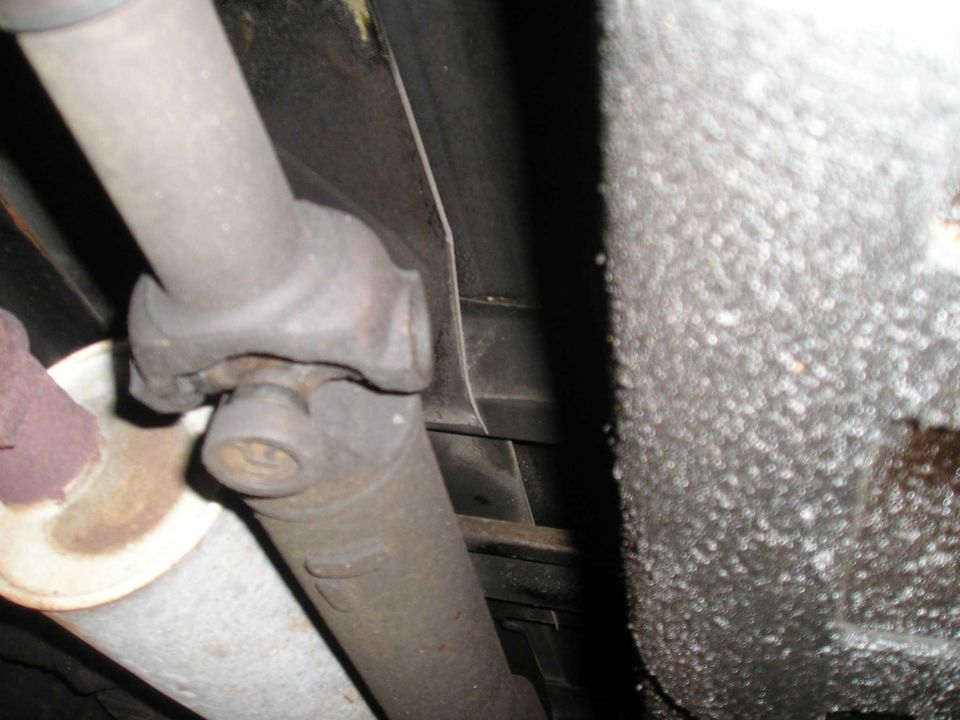 Driveshaft and exhaust pipe under a vehicle