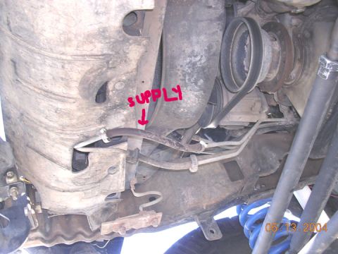 1994 Ford Bronco - here is where I cut the stock lines. the line on the left is the stock soft section return line that comes out of the auxilliary cooler. On…