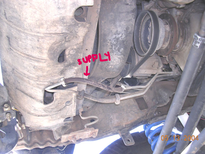 here is where I cut the stock lines.   the line on the left is the stock soft section return line that comes out of the auxilliary cooler.  On the right, the hard line bent and ran to the "radiator cooler".  I cut that, ran a soft line and piece of hard line to the bottom input of the new cooler, and then ran a soft hose from the top port on the new cooler to the input side of the stock auxiliary cooler