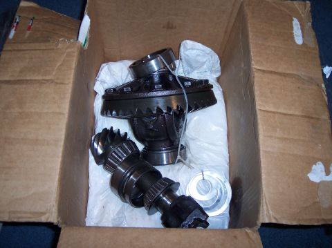1990 Ford Bronco - Differential gears and bearings are shown packed in a cardboard box, ready for installation or shipping.