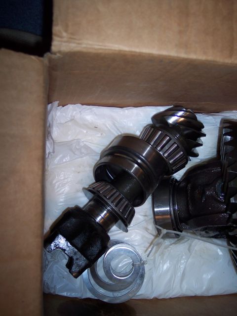 1990 Ford Bronco - Differential gears and bearings are shown inside a cardboard box.