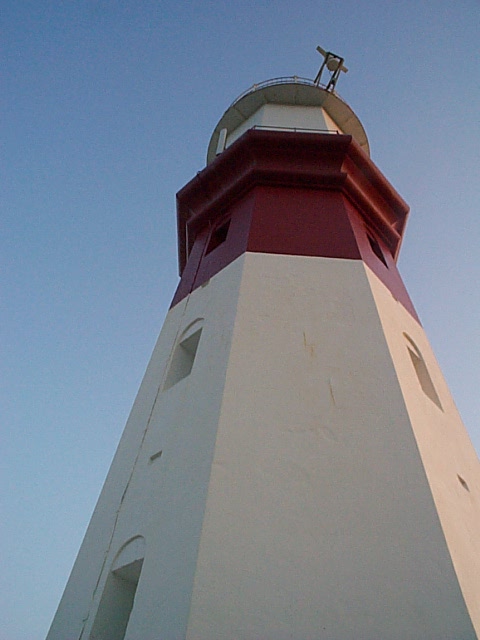 1994 Ford Bronco - A lighthouse stands tall against the sky, its red and white structure visible.
