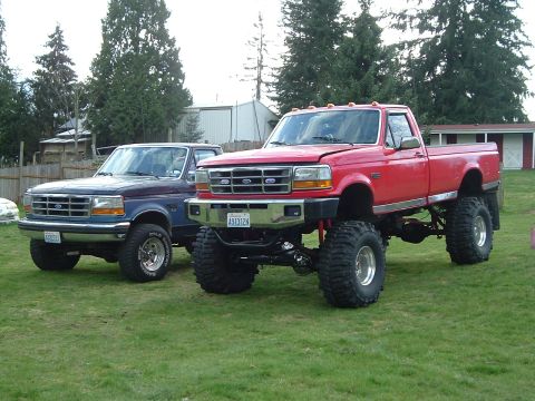 1993 Ford F-350 - Big Red next to my previous truck, a stock '92 F-250 on 33's.