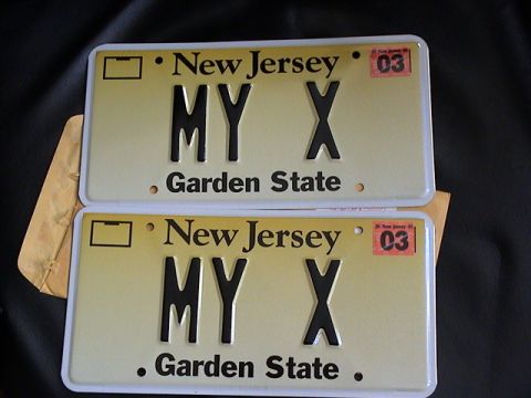 2003 Ford Excursion - Two New Jersey license plates, each showing 'MY X' and a 2003 expiration sticker.