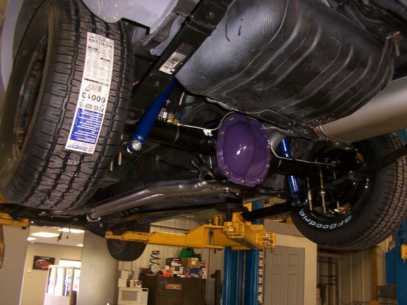 Underbody on a lift showing purple-painted differential, blue suspension links and BFGoodrich tires
