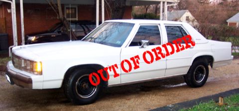 1991 Ford Crown Victoria LTD - White 1991 Ford Crown Victoria LTD sedan with 'OUT OF ORDER' stencil on the side.
