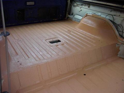1980 Ford Bronco - The cargo area of the vehicle has been coated with a textured orange material.