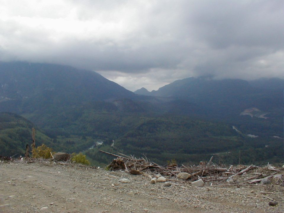 Mountainous landscape with a cloudy sky and debris in the foreground