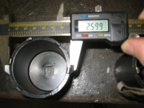 1994 Ford Bronco - A digital caliper measures a part with a square drive opening, indicating its dimensions.