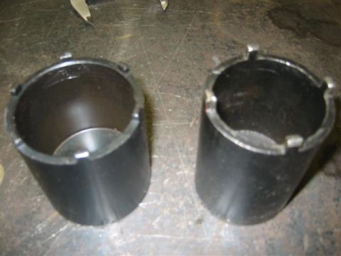 1994 Ford Bronco - Two specialized tools designed for removing hubcaps are shown on a workbench.