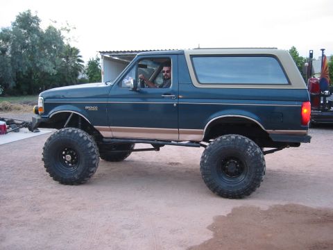 1994 Ford Bronco - This lifted 1994 Ford Bronco features oversized tires and a two-tone paint scheme with a tan top.