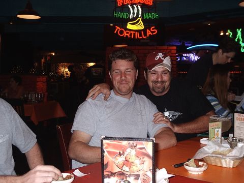 1993 Ford Bronco - Two men pose for a photo at a restaurant table, with a neon sign visible in the background.