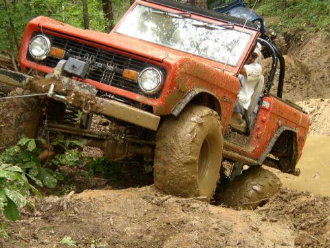 1995 Ford Bronco - This classic Ford Bronco is deep in the mud, showing off its off-road capabilities.
