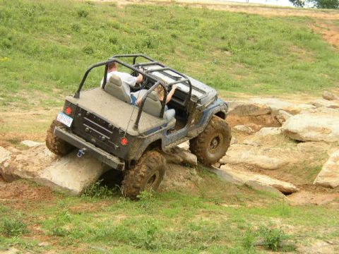 1995 Ford Bronco - A modified Jeep Wrangler navigates a challenging rocky obstacle course.