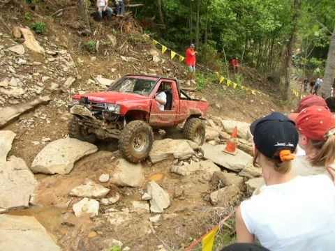 1995 Ford Bronco - Off-road Toyota pickup truck tackles a challenging rocky obstacle course.