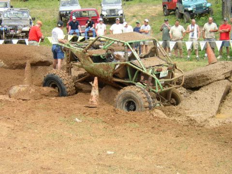 1995 Ford Bronco - Spectators watch as an off-road buggy struggles through a muddy obstacle course.