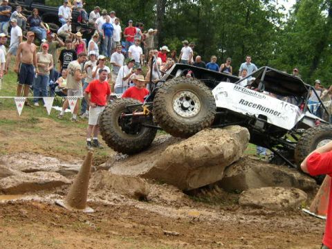 1995 Ford Bronco - A custom off-road buggy navigates a rocky obstacle course during a competition.