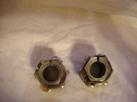 1993 Ford Bronco - Two metal automotive parts are shown against a light-colored fabric background, with a watermark at the bottom right.