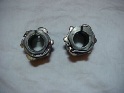 1993 Ford Bronco - Two metal hubs, possibly for a vehicle's drivetrain, are shown against a neutral background.
