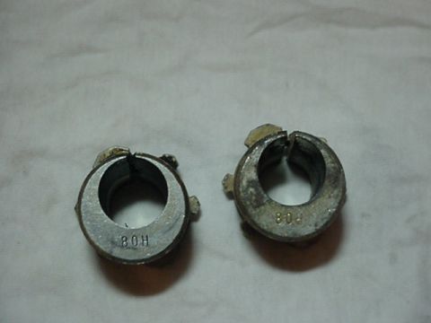 1993 Ford Bronco - Two metal hose clamps with visible markings are shown against a light-colored background.