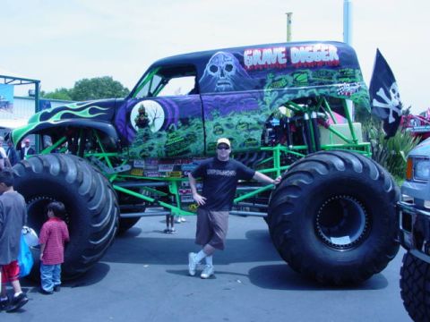 1992 Ford Bronco - The iconic Grave Digger monster truck is displayed with its distinctive skull and flame graphics, alongside a pirate flag.