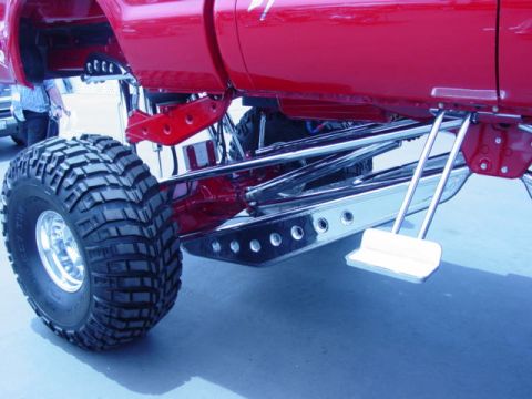 1992 Ford Bronco - Custom suspension and large tires on a lifted truck are visible in this close-up shot.