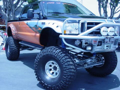 1992 Ford Bronco - This modified Ford Super Duty truck features a custom off-road bumper and large tires.