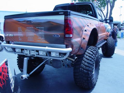 1992 Ford Bronco - This heavily modified Ford F-350 pickup truck features custom desert-themed graphics and a lifted suspension.
