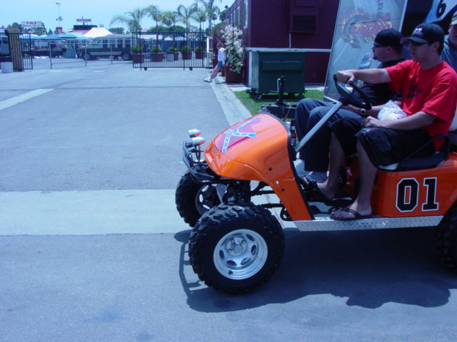 Orange golf cart with confederate flag decal and number 01