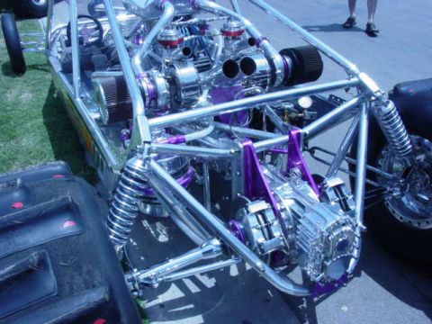 1992 Ford Bronco - This custom dragster features a complex engine setup with chrome and purple detailing.