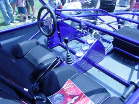 1992 Ford Bronco - Interior view of a custom buggy, a blue roll cage and dashboard gauges.