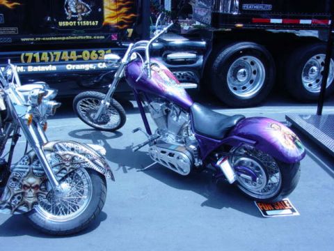 1992 Ford Bronco - Custom motorcycles with elaborate paint jobs are displayed at an event.