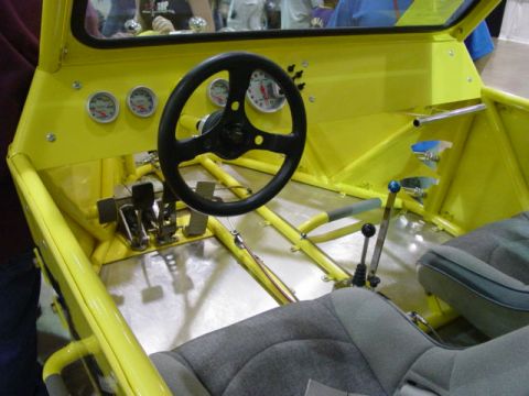 1992 Ford Bronco - Interior view of a custom buggy, a steering wheel, gauges, and shifters.