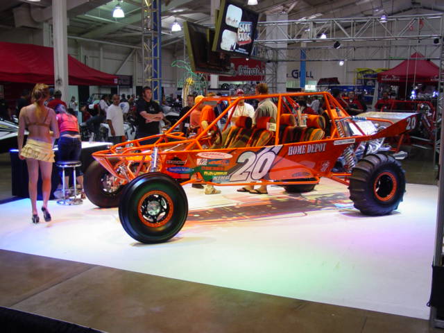 Orange dune buggy with "HOME DEPOT" and "20" graphics, on display