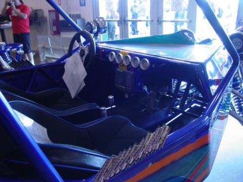 1992 Ford Bronco - Interior view of a custom blue dune buggy, racing seats, a steering wheel, and a dashboard with multiple gauges.