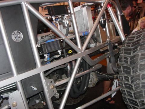1992 Ford Bronco - Close-up view of an off-road vehicle's engine compartment, highlighting its custom roll cage and mechanical components.