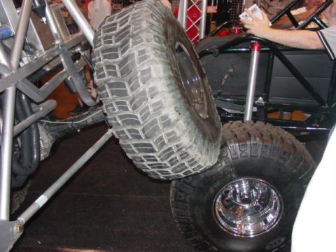 1992 Ford Bronco - Close-up view of the suspension and large off-road tires on a custom vehicle.
