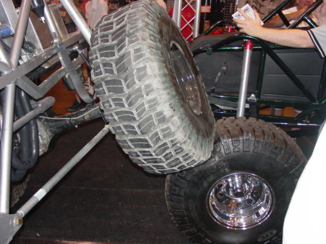 Off-road vehicle chassis with large tires and chrome rims