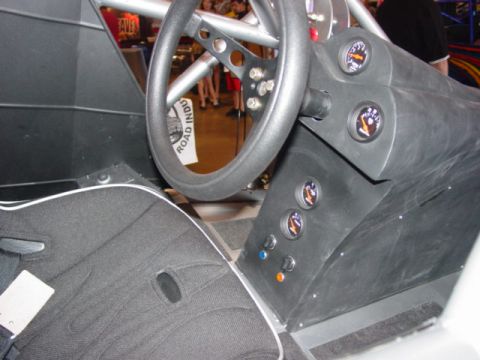 1992 Ford Bronco - The custom interior features a steering wheel, multiple gauges, and a racing seat, suggesting a performance-oriented vehicle.