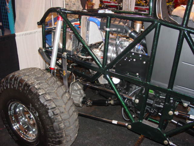 Green tube frame buggy with large tire and exposed engine