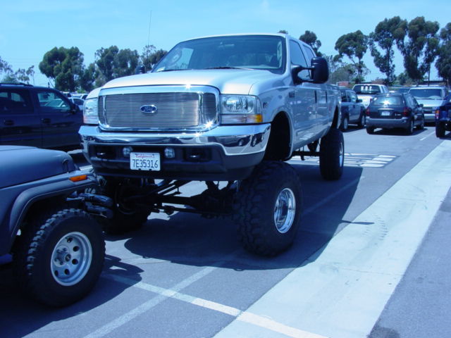 Silver lifted Ford F-250 Super Duty truck with large tires