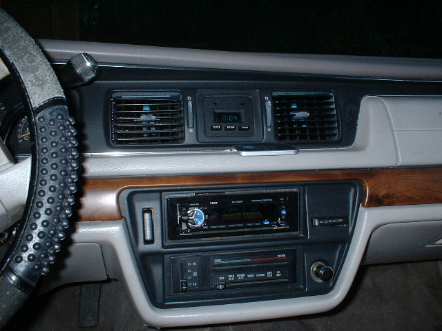 1992 Ford Crown Victoria interior dashboard with aftermarket stereo and climate controls